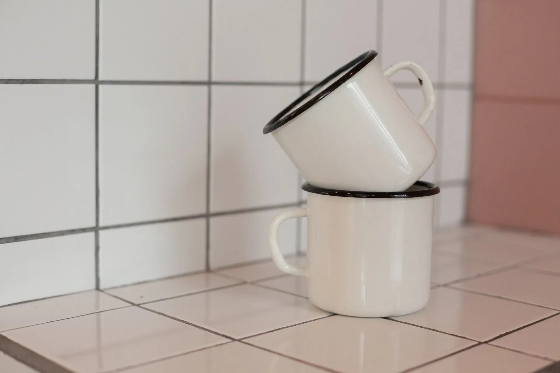 Two Foundry Mugs stacked one on the other against white tiles