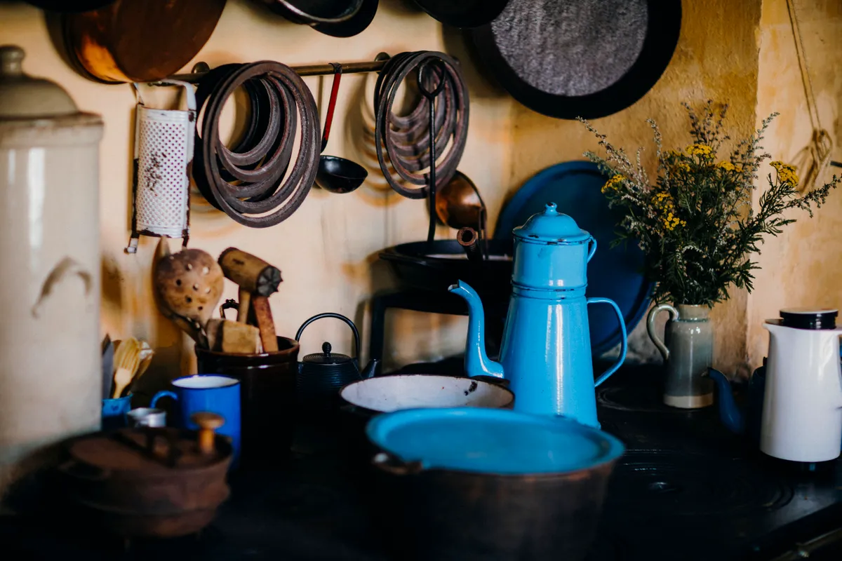Enamel kettle on a rustic kitchen stove